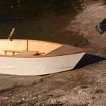 Одноместная гребная лодка с жестким корпусом.